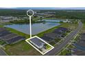 Stunning aerial view showcasing the home's location near a lake, lush greenery, and a serene neighborhood at 141 Mosaic Blvd, Daytona Beach, FL 32124