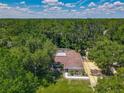 Beautiful aerial view of property with lush, green surrounding trees at 1516 Arrowhead Trl, Enterprise, FL 32725