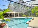 Large, screened-in pool area with ample seating and dining options at 1516 Arrowhead Trl, Enterprise, FL 32725