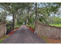 Long driveway approaching the home from an entrance gate at 1555 Mercers Fernery Rd, Deland, FL 32720