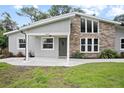 Beautifully updated home with stone accents, a modern door, and manicured lawn at 1620 20Th St, Orange City, FL 32763