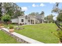 A well-maintained front yard features lush green grass and stone landscape accents at 1620 20Th St, Orange City, FL 32763