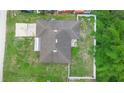 Aerial view of the property showing the roof, backyard, screened porch, and surrounding greenery at 1725 12Th St, Orange City, FL 32763