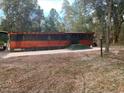 Exterior view of the home with a screened in porch and new patio at 17531 Ne 139Th Ave, Fort Mc Coy, FL 32134