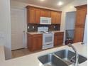 Updated kitchen featuring modern appliances, tiled floors, and ample cabinet space at 2051 Sherwood Forest Dr, Orange City, FL 32763