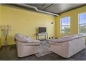 Bright living room with neutral furniture, high ceilings, and large windows at 208 Wall St # 204, Daytona Beach, FL 32114