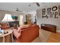 Cozy living room with plush furniture, a fireplace, and a view into the dining area at 2676 Palm Terrace St, Deland, FL 32720