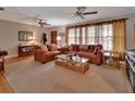 Spacious living room with two sofas, a decorative fireplace, and ample natural light at 2676 Palm Terrace St, Deland, FL 32720