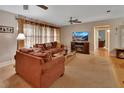Comfortable living room featuring neutral tones, plush seating, and a decorative fireplace at 2676 Palm Terrace St, Deland, FL 32720