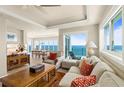 Spacious living room featuring views to the dining room and floor to ceiling windows overlooking the ocean at 2801 Hill St # 801, New Smyrna Beach, FL 32169