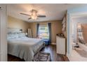 Comfortable bedroom with natural light, hardwood floors, and ensuite bathroom at 3013 Hunkin Cir, Deltona, FL 32738