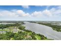 Beautiful aerial view of the river from the home and surrounding landscape with beautiful clouds at 317 River Front Way, Edgewater, FL 32141