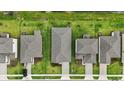 Aerial view of neighborhood homes showing roof lines, driveways and landscaping features at 317 River Front Way, Edgewater, FL 32141