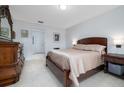 Cozy bedroom featuring neutral walls, tile flooring, and a comfortable bed at 3810 Arboreal Ct, Deland, FL 32724