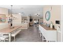 Open-concept dining room featuring stylish lighting fixture, wood-look flooring, and a decorative console table at 413 Coventry Estates Blvd, Deltona, FL 32725