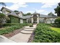 Charming home featuring lush landscaping, inviting walkway, and elegant architectural details at 420 Greenridge Ct, Debary, FL 32713