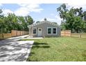 Charming single-story home with a manicured lawn and a newly paved driveway and fenced in yard at 429 W Carolina Ave, Deland, FL 32720