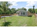 Well-maintained home showcasing a lush front lawn, fenced in yard, and freshly paved driveway at 429 W Carolina Ave, Deland, FL 32720