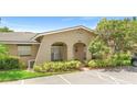 A condo showcasing a well-maintained exterior and lush landscaped front yard at 511 Polaris Loop # 105, Casselberry, FL 32707
