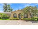 Lovely exterior view of condo featuring manicured landscaping and arched entryway at 511 Polaris Loop # 105, Casselberry, FL 32707