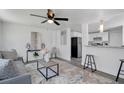 Bright living room with modern furnishings, ceiling fan, and stylish decor adjacent to a view of the kitchen at 528 Pine St, Daytona Beach, FL 32114