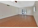 Spacious living room with wood floors, ceiling fan and French doors at 600 N Boundary Ave # 420, Deland, FL 32720