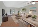 Bright living area with French doors, wood floors, and stylish furniture at 600 N Boundary Ave # 420, Deland, FL 32720