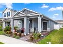 Charming single-story home with a well-manicured lawn and inviting front porch with landscaping at 614 Becklow St, Debary, FL 32713