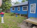 Side view of blue house showcasing outdoor garden with grass and plants at 615 Weber Ave, Daytona Beach, FL 32114