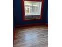 Bedroom with hardwood floors, built in shelf, and windows facing the backyard at 615 Weber Ave, Daytona Beach, FL 32114