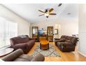 Bright living room featuring wood floors, vaulted ceilings, ceiling fan and comfortable seating arrangements at 685 N Firwood Dr, Deltona, FL 32725