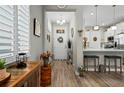 Bright entryway featuring hardwood floors and views of the kitchen at 7732 Sw 86Th Ct, Ocala, FL 34481