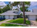 Home featuring manicured landscaping, a private driveway, and a welcoming facade at 955 Grayling Ct # B, Port Orange, FL 32127