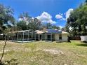Expansive backyard with a screened-in pool area, offering a private outdoor oasis at 955 Thelma St, Orange City, FL 32763