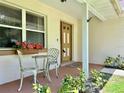 Inviting front porch with a cozy seating area and decorative plants, perfect for relaxing at 955 Thelma St, Orange City, FL 32763