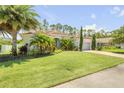 Beautiful single-story home with a well-manicured lawn and lush landscaping at 101 Briargate Look, Ormond Beach, FL 32174