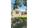 Charming single-story home with red trim, a well-manicured lawn, and mature trees at 1025 Persian St, Deltona, FL 32725