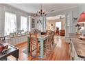 Spacious dining room with a chandelier, large windows, and hardwood floors, ideal for Gathering gatherings and entertaining guests at 1056 Stevens St, Lake Helen, FL 32744