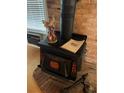 Close up of wood burning stove against a red brick accent wall at 110 Amigos Rd, Debary, FL 32713