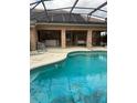 Large screened-in pool with an attached porch with chairs and a swing for relaxing and outdoor living at 1118 Prescott Blvd, Deltona, FL 32738