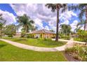 Landscaped house with solar panels, a walkway, and lush green lawn at 1131 Lemonwood Ave, Deland, FL 32724