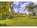 Beautiful single-story home with a well-manicured lawn and tropical foliage at 1131 Lemonwood Ave, Deland, FL 32724