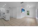 Bright living room with tile flooring, neutral walls, and modern fixtures offer a cozy and inviting space at 1214 Flomich St, Daytona Beach, FL 32117