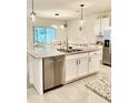 Modern kitchen with granite countertops, stainless steel appliances, and a large island with a sink and dishwasher at 1216 August Sky Dr, Deltona, FL 32738