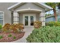 Inviting entryway with double doors and neatly manicured landscaping creating curb appeal at 1329 Sunningdale Ln, Ormond Beach, FL 32174