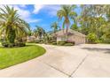 Beautiful home with lush green lawn, circular driveway and three-car garage at 15 Cambridge Trce, Ormond Beach, FL 32174