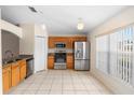 Bright eat-in kitchen featuring stainless steel appliances, granite counters, and tile flooring at 1561 Randolph St, Deltona, FL 32725