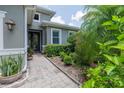 Inviting home entrance featuring lush landscaping and a brick walkway to the front door at 1653 Victoria Gardens Dr, Deland, FL 32724