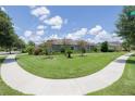 Expansive lawn surrounds a charming home with mature trees and landscaped features at 1653 Victoria Gardens Dr, Deland, FL 32724