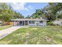 Inviting exterior view of the home featuring a covered porch, landscaped yard, and freshly painted exterior at 173 Cedar Ave, Orange City, FL 32763